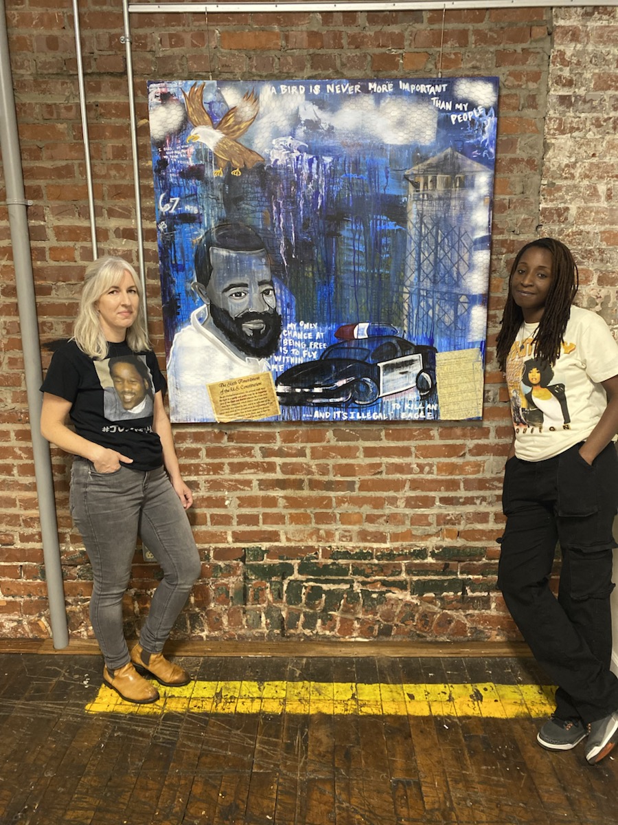 Owens-Murphy and Casey pose in front of Kerrigan Casey’s portrait of Nathaniel Woods, who was executed by the state of Alabama in 2020.