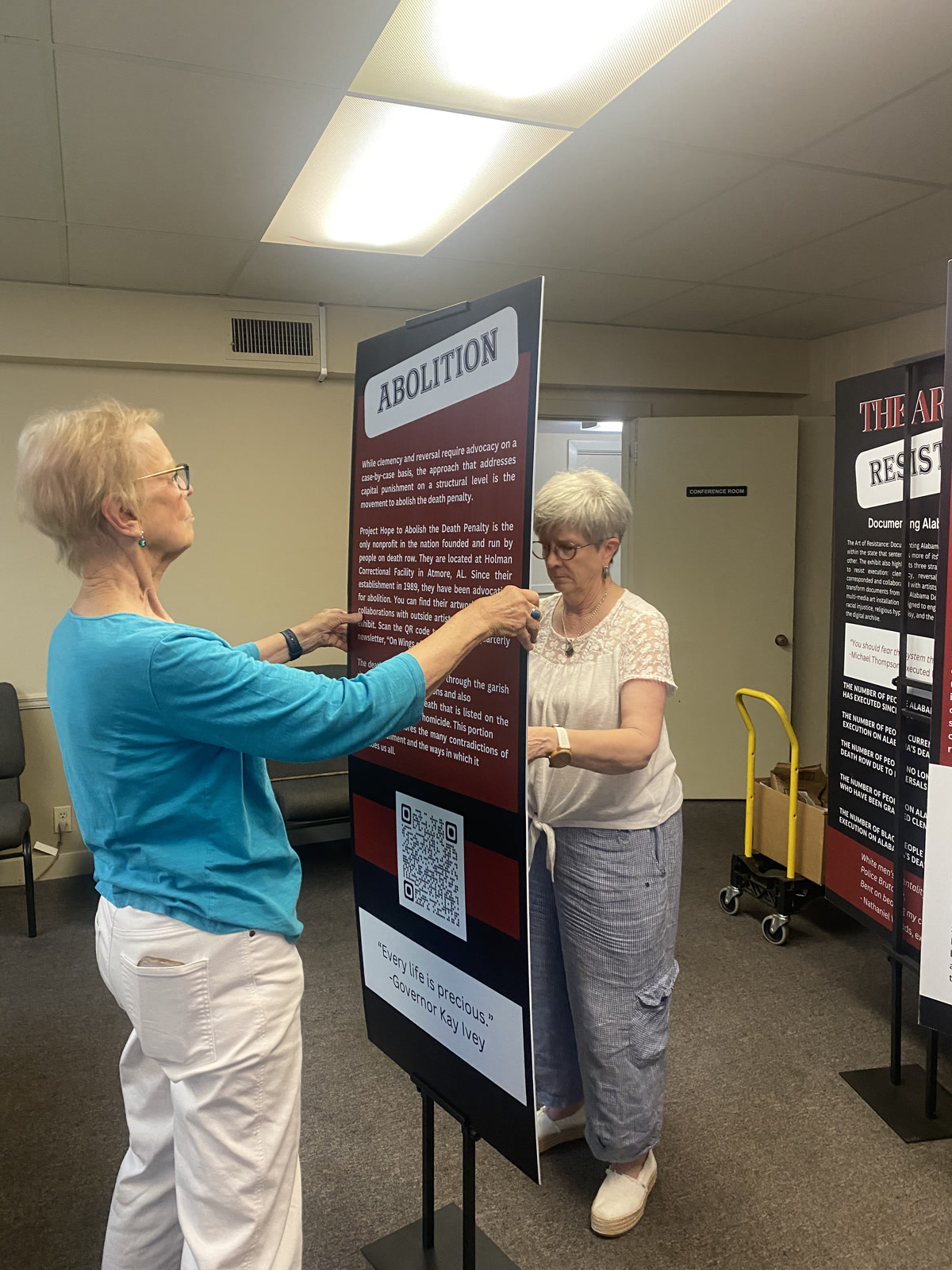 Volunteers from Grace Presbyterian Church help install the exhibit in Tuscaloosa, Alabama.